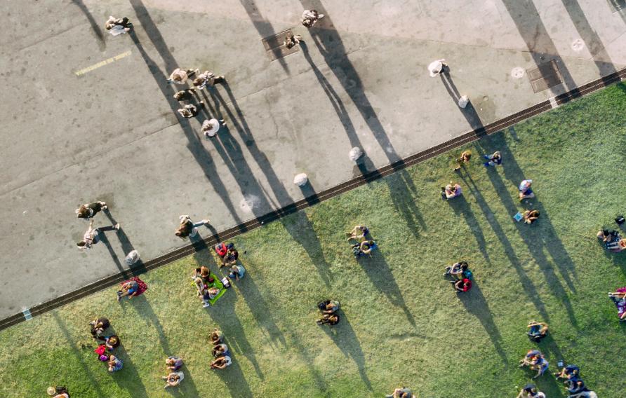 Aerial view of people on grass and pavement