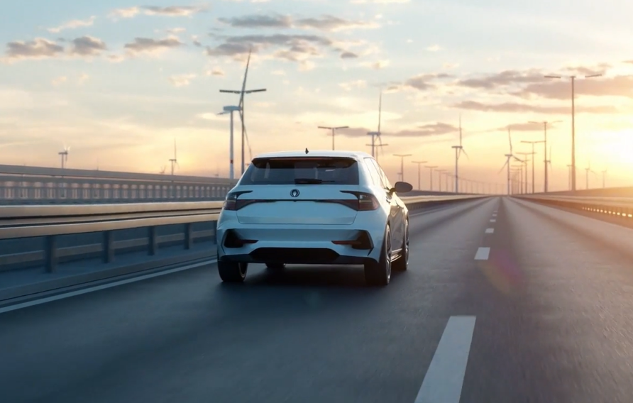 Car traveling toward sunset with wind energy